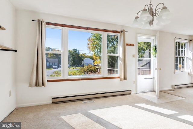 interior space featuring an inviting chandelier, a baseboard heating unit, and light colored carpet