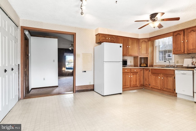 kitchen with sink, white appliances, and ceiling fan