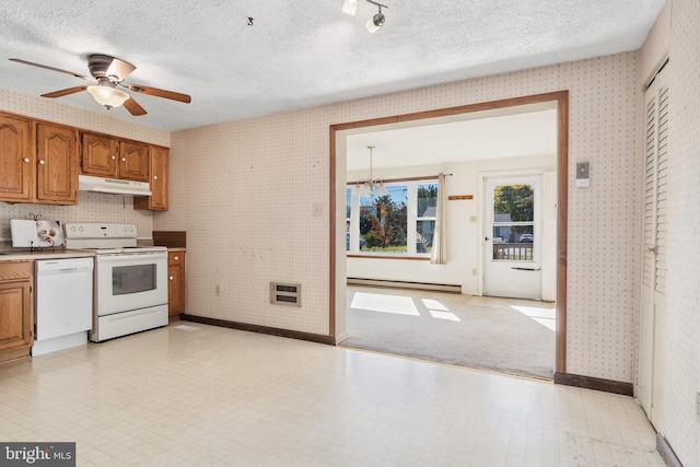 kitchen with a textured ceiling, a baseboard radiator, and white appliances