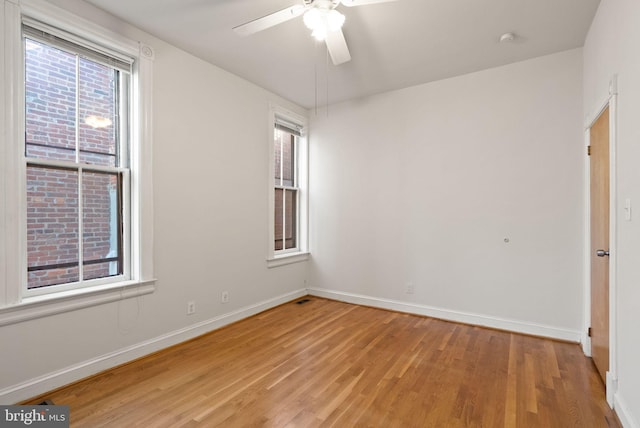 unfurnished room with ceiling fan and light wood-type flooring