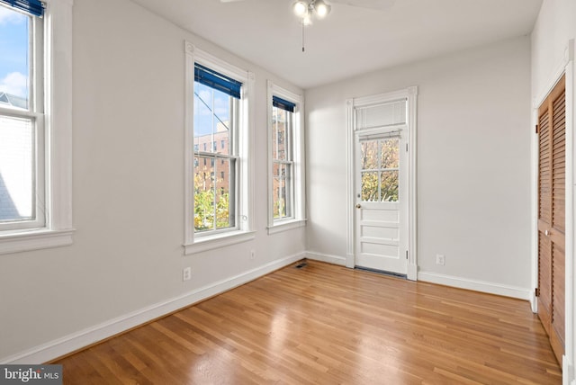 unfurnished bedroom featuring a closet, light wood-type flooring, and ceiling fan