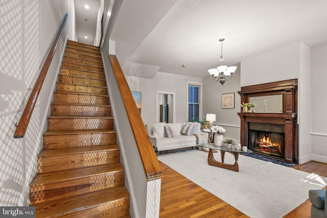 stairway featuring hardwood / wood-style flooring and a chandelier