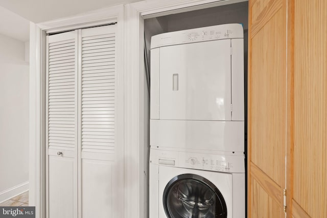 clothes washing area with stacked washer and clothes dryer