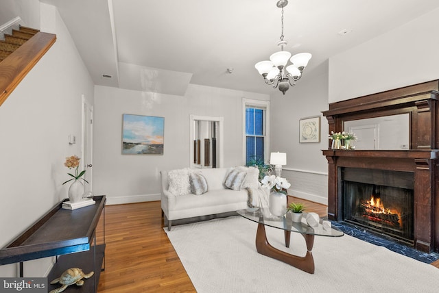 living room featuring hardwood / wood-style floors and an inviting chandelier