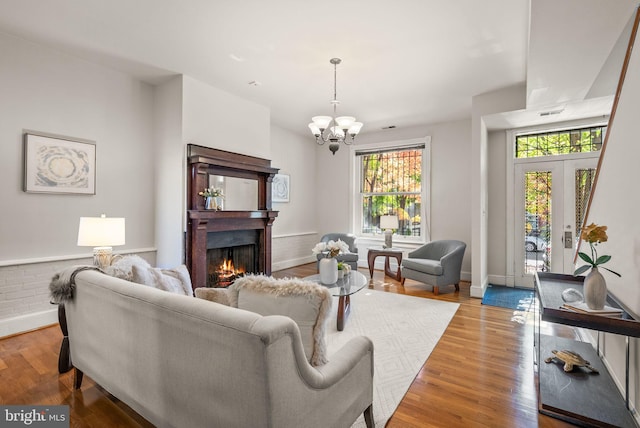 living room featuring a chandelier and light hardwood / wood-style flooring