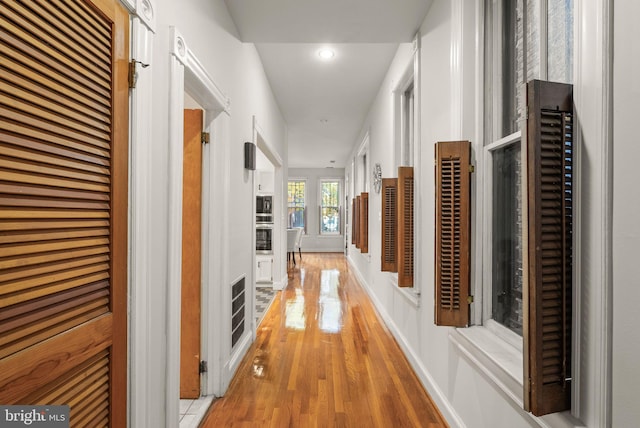 hallway with light hardwood / wood-style flooring