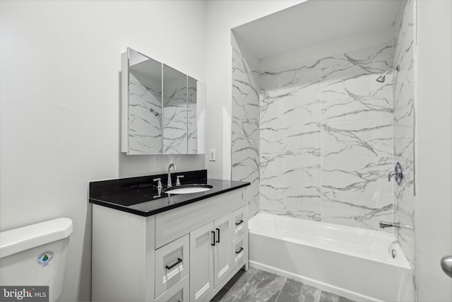 full bathroom with vanity, tiled shower / bath combo, and toilet