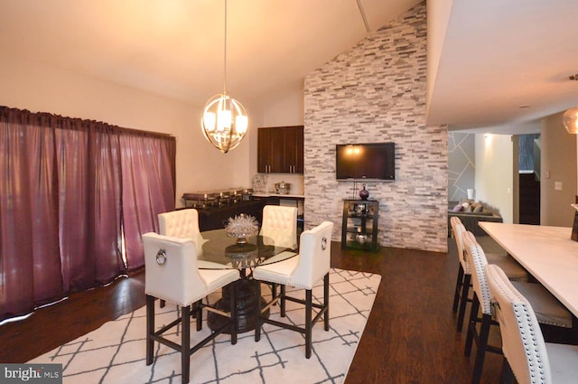 dining room with an inviting chandelier, light wood-type flooring, and high vaulted ceiling