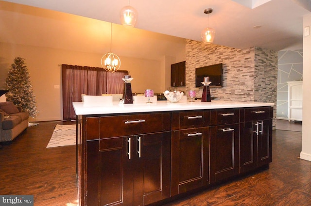 kitchen featuring dark hardwood / wood-style flooring, decorative light fixtures, dark brown cabinetry, and a notable chandelier