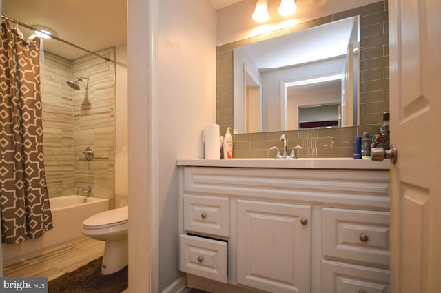 full bathroom with wood-type flooring, shower / bath combo with shower curtain, toilet, vanity, and backsplash