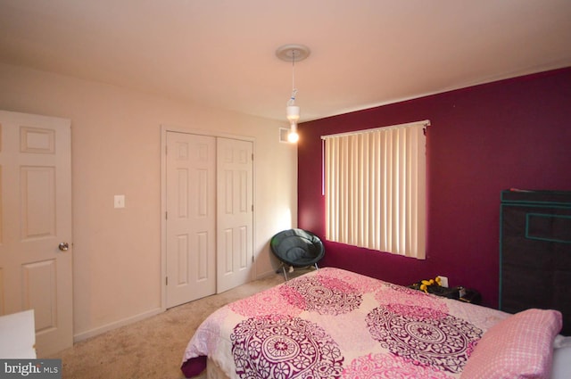 bedroom featuring a closet and light carpet