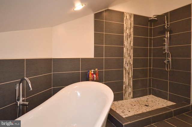 bathroom featuring separate shower and tub and tile walls