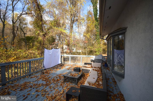 wooden deck featuring a fire pit