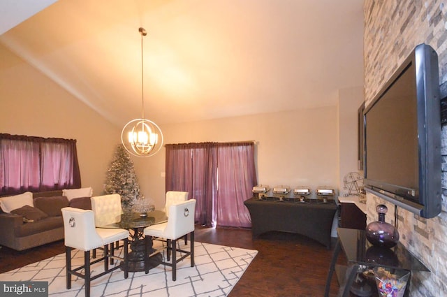 dining area featuring hardwood / wood-style flooring, lofted ceiling, and a notable chandelier