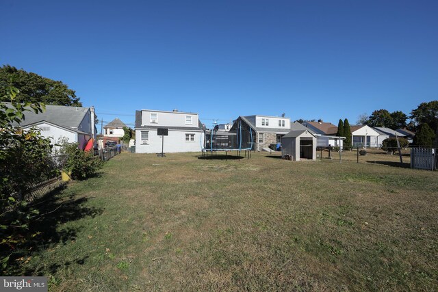 view of yard with a storage unit and a trampoline