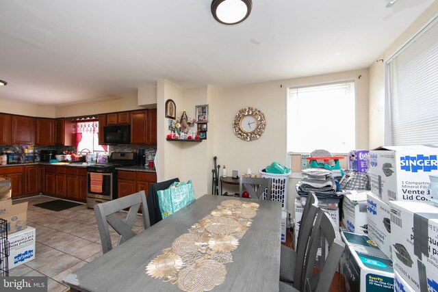 dining area with sink and light tile patterned floors