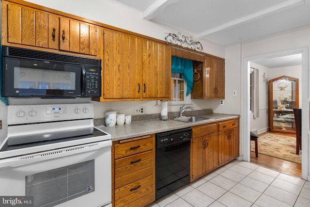 kitchen featuring black appliances, light wood-type flooring, and sink