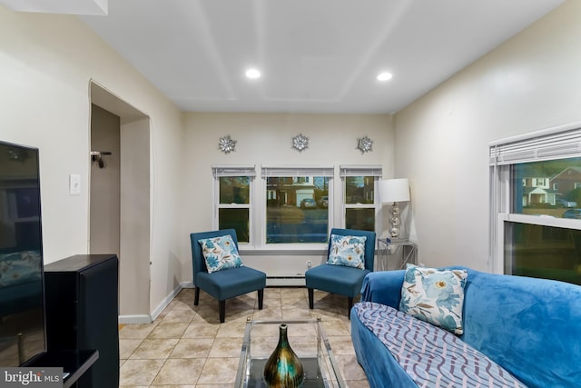 living room with a baseboard radiator and light tile patterned floors