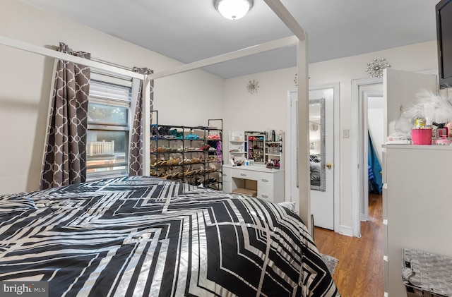 bedroom with hardwood / wood-style floors