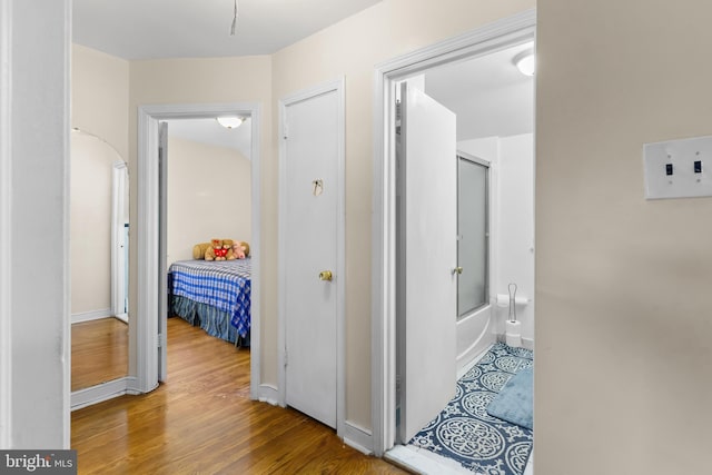 hallway with hardwood / wood-style floors