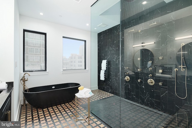 bathroom featuring vanity and separate shower and tub