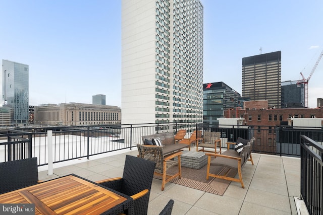 view of patio with outdoor lounge area and a balcony