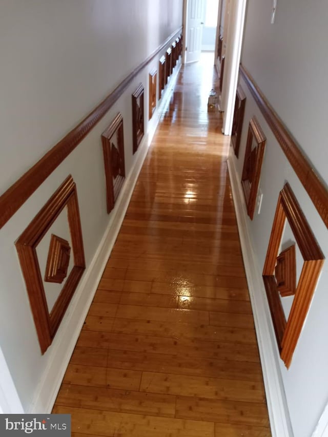 hall with hardwood / wood-style floors