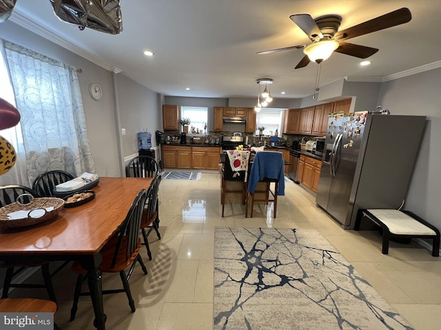 dining room with ceiling fan, ornamental molding, and light tile patterned floors