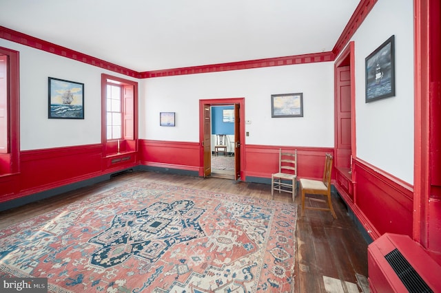 sitting room featuring crown molding and dark hardwood / wood-style flooring