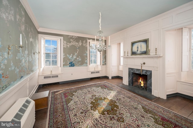 living room featuring ornamental molding, a chandelier, and dark hardwood / wood-style flooring