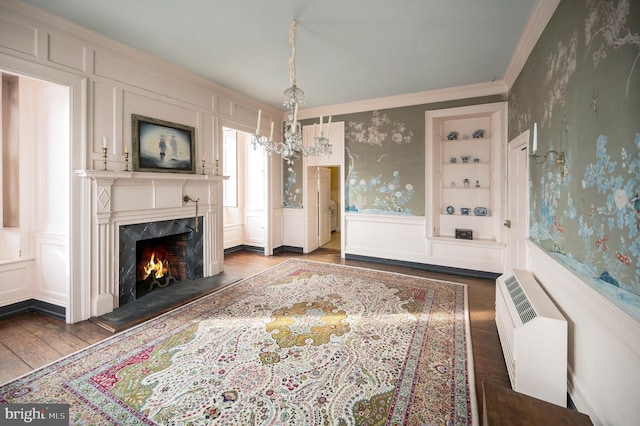 interior space with crown molding, a fireplace, a chandelier, and dark hardwood / wood-style flooring