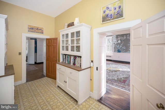 corridor with light hardwood / wood-style floors