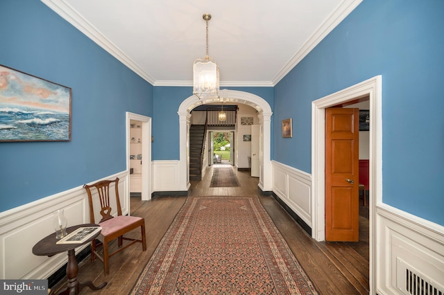 hall with crown molding and dark hardwood / wood-style floors