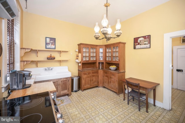 interior space with a healthy amount of sunlight, decorative light fixtures, and a chandelier