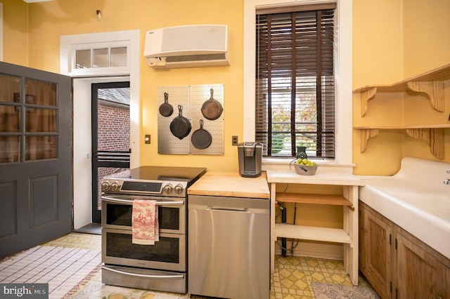 kitchen with stainless steel appliances and light tile patterned floors