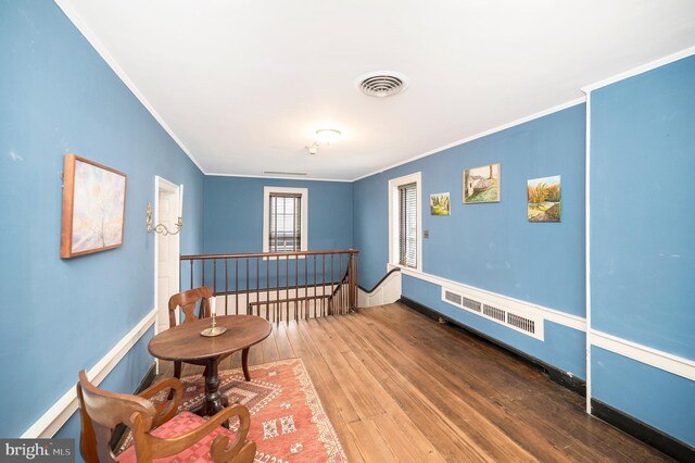 sitting room featuring hardwood / wood-style flooring and ornamental molding