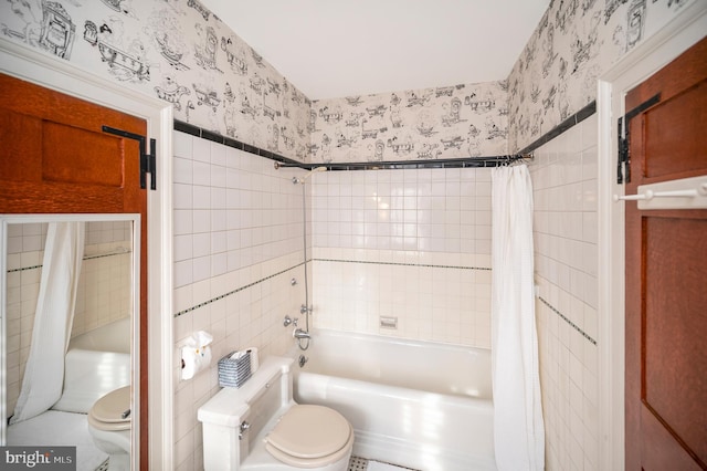 bathroom with toilet, shower / bath combo, and tile walls