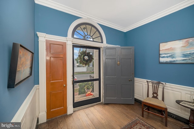 foyer with crown molding and light wood-type flooring