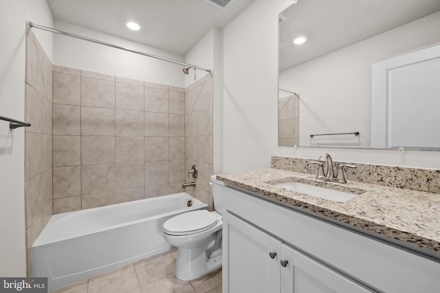 full bathroom with vanity, tile patterned flooring, toilet, and tiled shower / bath combo