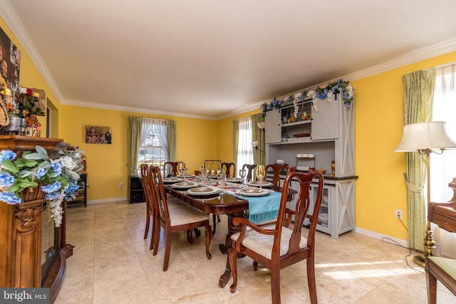 tiled dining area featuring ornamental molding