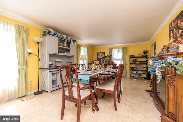 dining space featuring ornamental molding and light tile patterned floors