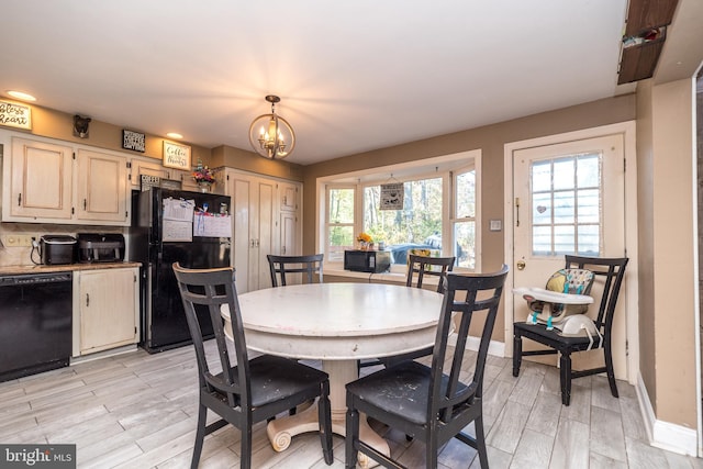 dining room featuring light hardwood / wood-style flooring and a chandelier