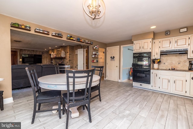 dining area with a chandelier and light hardwood / wood-style flooring