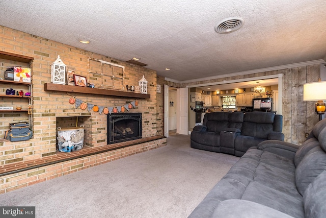 living room with carpet flooring, a textured ceiling, a fireplace, and ornamental molding