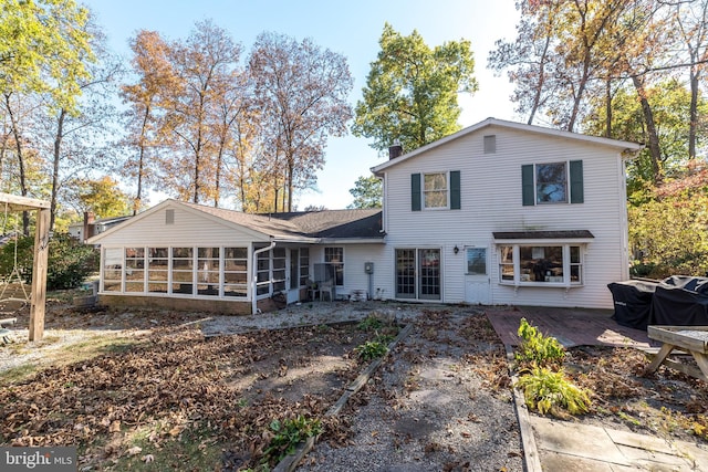 back of property featuring a sunroom