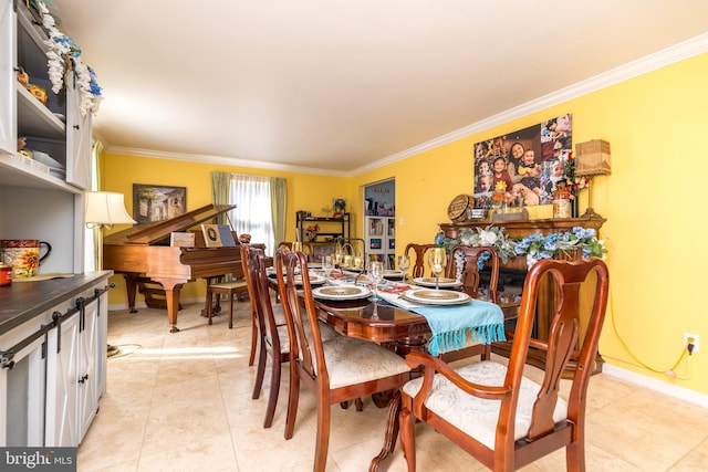 tiled dining room featuring crown molding