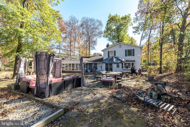 back of property featuring an outdoor hangout area and a patio