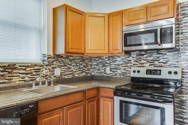 kitchen with sink, appliances with stainless steel finishes, and tasteful backsplash