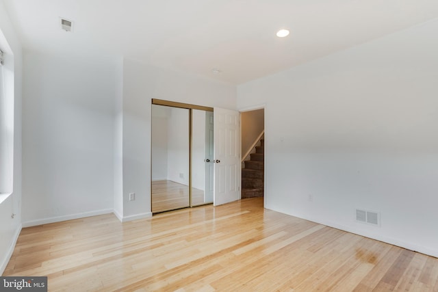 empty room with light hardwood / wood-style flooring