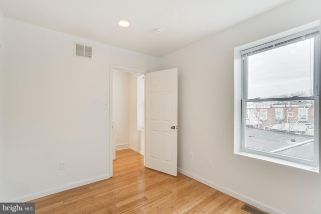 unfurnished room with light hardwood / wood-style flooring